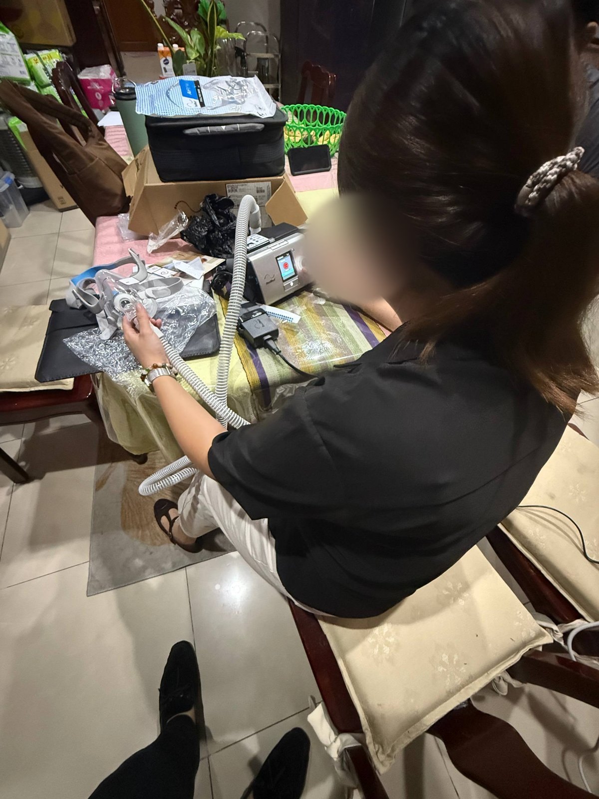 A respiratory therapist preparing the machine and mask at setup