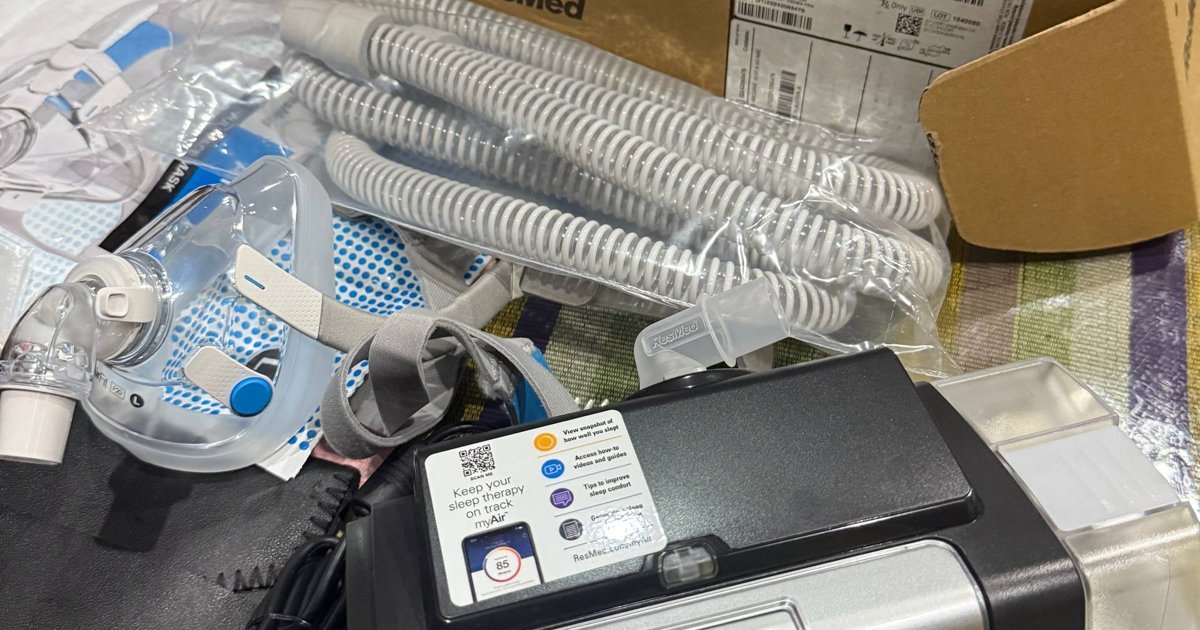 ResMed BiPAP machine, tubing and mask laid out at a home setup